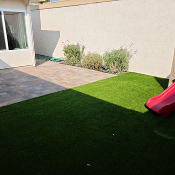 Ecosite Landscaping - Backyard with quarry stone pavers and artificial turf. - Landscaping Near Me