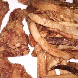 A close-up shot, wings small & thin, fries limp & oily. A close-up shot, wings small & thin, fries limp & oily.