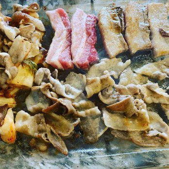Han Joo Chik Naeng Myun & BBQ - Our pork cooking away on the crystal grill - Korean Near Me - Flushing, New York