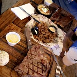 Cowboy Coast Country Saloon - Medium rare porterhouse steak with smoked cream corn and mashed potato. My bf had the full rack of ribs.