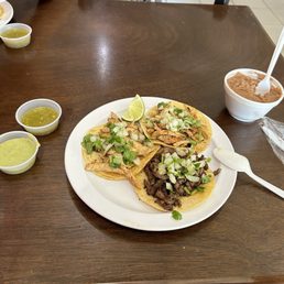 Asada and chicken street tacos with salsa and beans Asada and chicken street tacos with salsa and beans