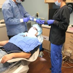 Dental Implant Solutionz - Dentist and dental hygienist performing dental implant procedure