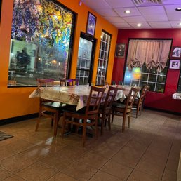 a dinning room with a table and chairs a dinning room with a table and chairs