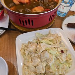 chopped cabbage and the top is a beef with potatoes and tomatoes. chopped cabbage and the top is a beef with potatoes and tomatoes.