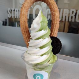 a cup of ice cream and a churros a cup of ice cream and a churros