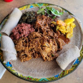 Beteseb Restaurant - Fitfit, kitfo, gomen wot, salad green, tibs awase, alitkilt [cabbage & potatoes] on and surrounded by delicious injera - Ethiopian Near Me - Silver Spring, Maryland