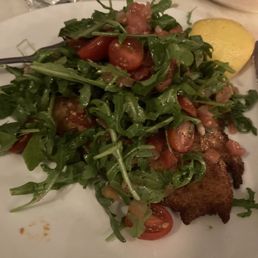Chicken Milanese covered with lemon seasoned Arugula salad Chicken Milanese covered with lemon seasoned Arugula salad