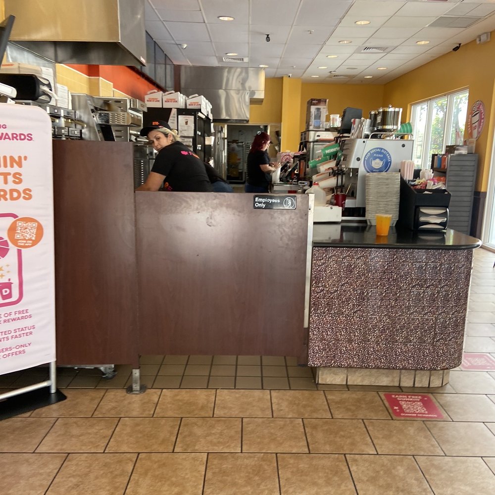 Dunkin' - a man behind a counter in a restaurant - Coffee & Tea Near Me - Miami, Florida Dunkin' - a man behind a counter in a restaurant - Coffee & Tea Near Me - Miami, Florida
