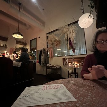 Heavenly Creatures - a woman sitting at a table in a restaurant - Wine Bars Near Me - Portland, Oregon Heavenly Creatures - a woman sitting at a table in a restaurant - Wine Bars Near Me - Portland, Oregon