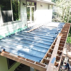 Stellar Construction - dry-dek, sloping from house out.  Will come with a gutter system.