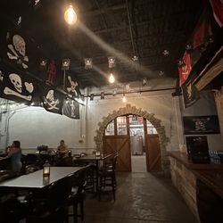 Gasparilla Distillery & Cocktail Bar - Back seating are & distillery in the back