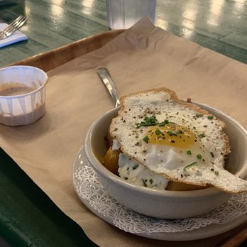 Rodeo Goat - Tater tots with goat cheese and an egg on top ($7.5); there are 7-8 tots which means each tot is about $1 - Burgers Near Me - Houston, Texas