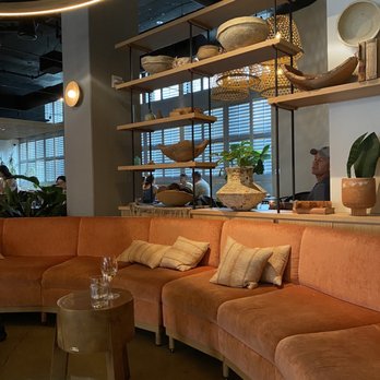 Condesa - a modern living room with orange couches - Mexican Near Me - Philadelphia, Pennsylvania Condesa - a modern living room with orange couches - Mexican Near Me - Philadelphia, Pennsylvania
