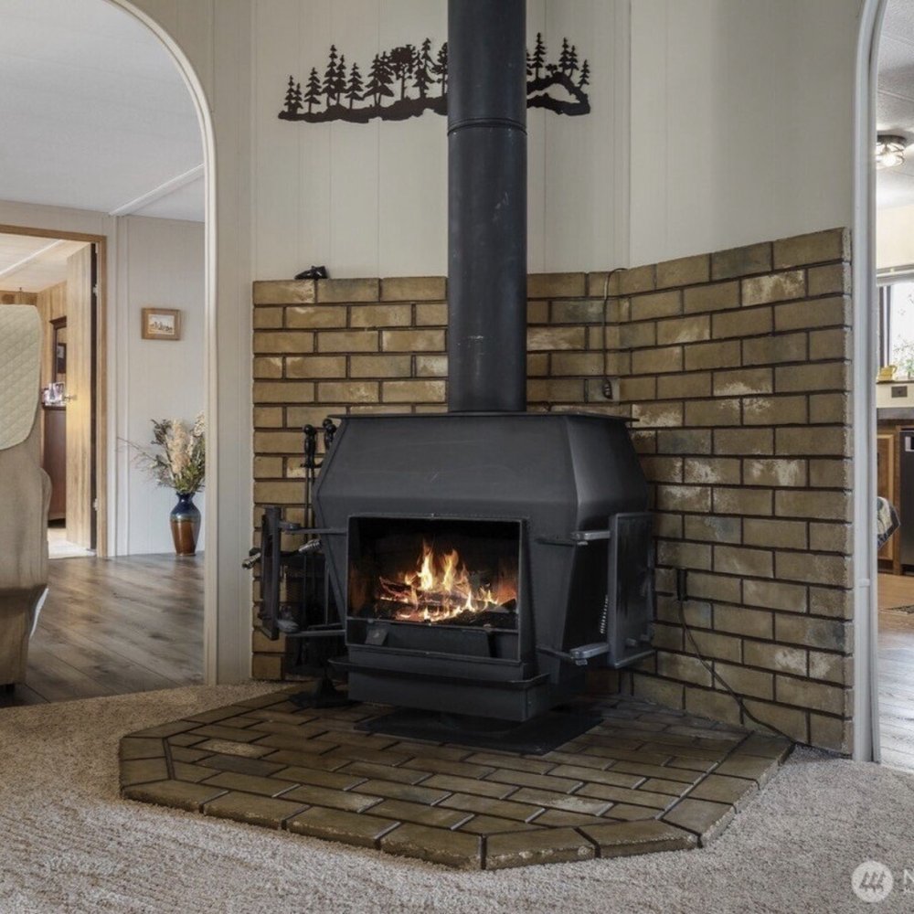 Every Door Real Estate - Comfy cozy wood stove in the living room. - Real Estate Services Near Me - Seattle, Washington