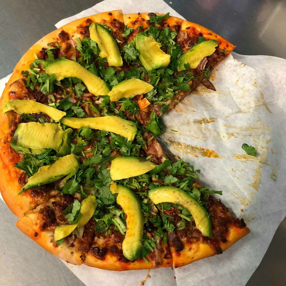 The Chorizo Fest Pizza is bomb! Loaded with Chorizo, Onions, Cilantro and Avocado! instead of tomato sauce they put green salsa! The Chorizo Fest Pizza is bomb! Loaded with Chorizo, Onions, Cilantro and Avocado! instead of tomato sauce they put green salsa!