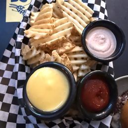 Waffle fries with egg yolk aioli, seasoned sour cream and ketchup