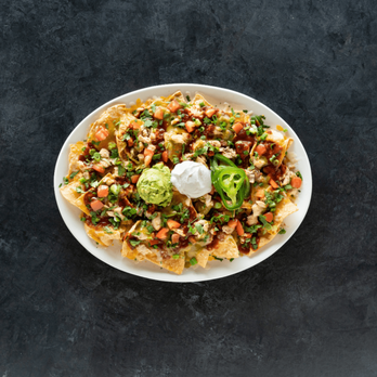 Yard House - Enjoy a variety of appetizers, like our Chicken Nachos, while watching your favorite sports games. - Bars Near Me - Westlake, Ohio