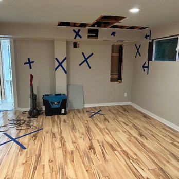 Apollo Plumbing and Rooter - Every blue X is where water went into the walls and into the floors, buckling the wood laminate. - Plumbing Near Me - Everett, Washington Apollo Plumbing and Rooter - Every blue X is where water went into the walls and into the floors, buckling the wood laminate. - Plumbing Near Me - Everett, Washington