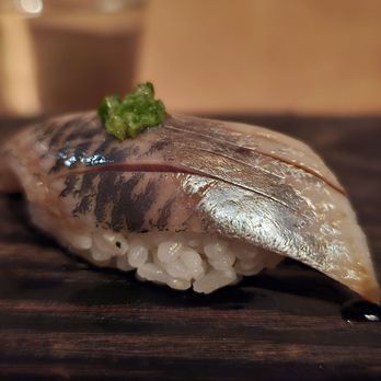 Nimblefish - a piece of sushi on a chopping board - Sushi Bars Near Me - Portland, Oregon