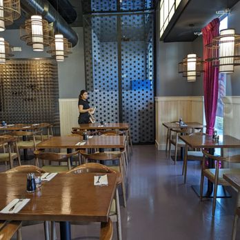 Izumi Japanese Restaurant - a woman standing in the dining room - Japanese Near Me - Eagle, Idaho Izumi Japanese Restaurant - a woman standing in the dining room - Japanese Near Me - Eagle, Idaho