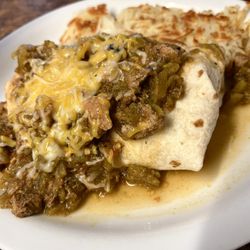 Pippo's Cafe - Breakfast burrito smothered with pork green chili