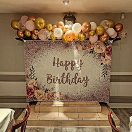 Birthday decorations and banner covering the fireplace. Birthday decorations and banner covering the fireplace.