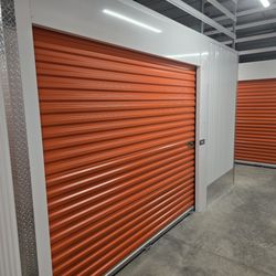 Personal Mini Storage - Clean, indoor self-storage units with secure roll-up doors and wide, well-lit access aisles