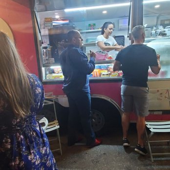 Boni Bakery - Customers are standing at a dessert and coffee food truck, placing orders with the staff inside. - Desserts Near Me