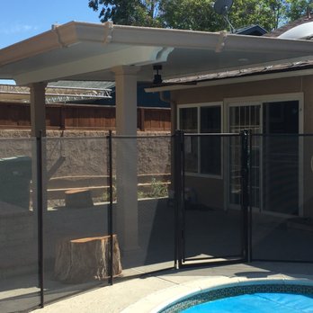 Patio Warehouse - The cover connects to the roof of our house with several brackets. During strong winds a good amount of leaves do get under the cover. - Patio Coverings Near Me - Orange, California