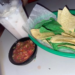 Chips and pico de gallo along with some horchata . Chips and pico de gallo along with some horchata .