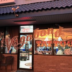 Vagabond Tattoo - Our Studio entrance, Maui sunset reflected in the window. Tattoo shop walk-ins welcome