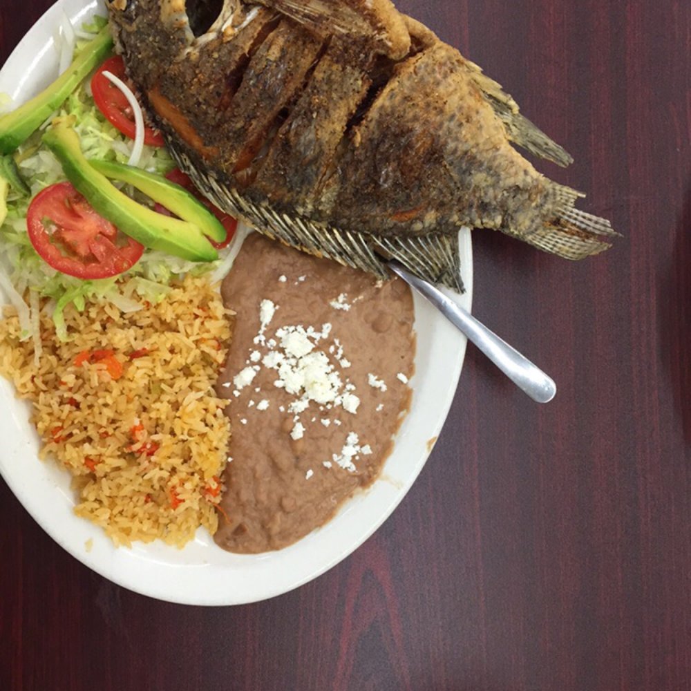 Fried whole fish, rice, beans, and side salad in the cafe in the back of Mi Pueblo Fried whole fish, rice, beans, and side salad in the cafe in the back of Mi Pueblo