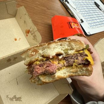 McDonald's - a hand holding a half eaten sandwich - Fast Food Near Me - Siloam Springs, Arkansas McDonald's - a hand holding a half eaten sandwich - Fast Food Near Me - Siloam Springs, Arkansas