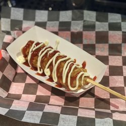 LuckyDog - Korean Corn dog with cube fries on the outside topped with ketchup and mayo.