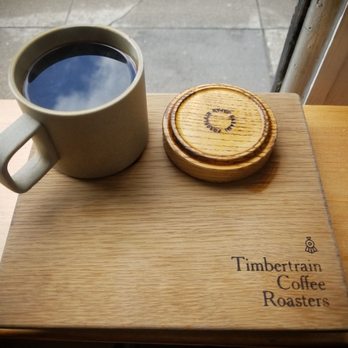 Timbertrain Coffee Roasters - Gastown - cute wooden board with shallow cup holder so you dont spill the good stuff - Coffee Roasteries Near Me - Vancouver, British Columbia Timbertrain Coffee Roasters - Gastown - cute wooden board with shallow cup holder so you dont spill the good stuff - Coffee Roasteries Near Me - Vancouver, British Columbia