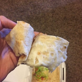 Pollo Feliz - a hand holding a burrito - Mexican Near Me - Greeley, Colorado