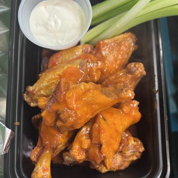 PIZZA 21st - a tray of chicken wings and a bowl of ranch dip - Pizza Near Me - New York, New York