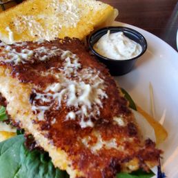 Parmesan crusted walleye sandwich, with the top of the bun off to the side.