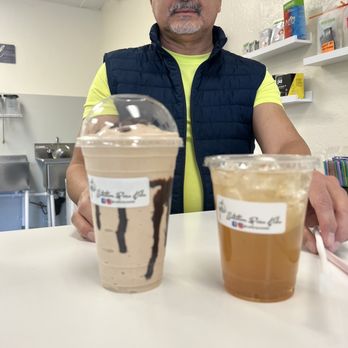 Nutrition Pura Vida - Jose and his masterpieces - yum! Chocolate banana split protein shake and a peach tea! - Juice Bars & Smoothies Near Me - Phoenix, Arizona