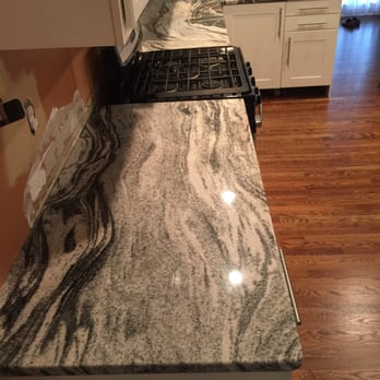 Iib Stone - a kitchen counter with a stove top - Flooring Near Me - Suwanee, Georgia Iib Stone - a kitchen counter with a stove top - Flooring Near Me - Suwanee, Georgia