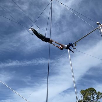 Aerial Trapeze Academy - Holly is stretched out ready for the transfer. - Performing Arts Near Me - West Palm Beach, Florida