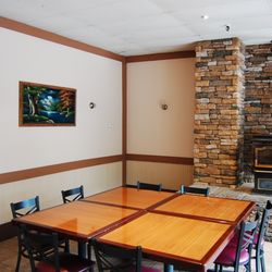 Guido's Pizzeria - Dining room tables and wood stove