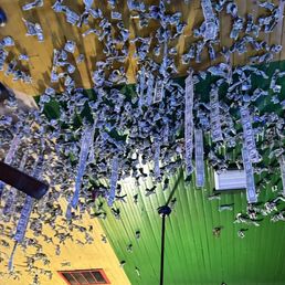 Dollar bills with tacks tossed up and stuck to the ceiling is a popular local custom!