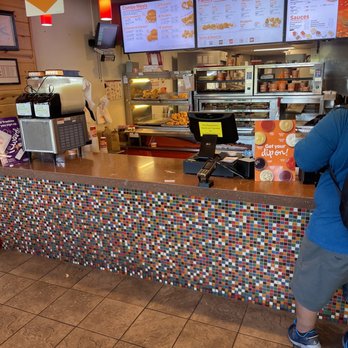 Popeyes Louisiana Kitchen - a man standing at a counter - Chicken Wings Near Me - Deforest, Wisconsin Popeyes Louisiana Kitchen - a man standing at a counter - Chicken Wings Near Me - Deforest, Wisconsin