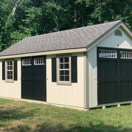 Exterior outside entrance of The Shed Haus - 12x20 Cape Cod Deluxe in Navajo White, Clay trim and Black Door. - Pawling, New York Exterior outside entrance of The Shed Haus - 12x20 Cape Cod Deluxe in Navajo White, Clay trim and Black Door. - Pawling, New York