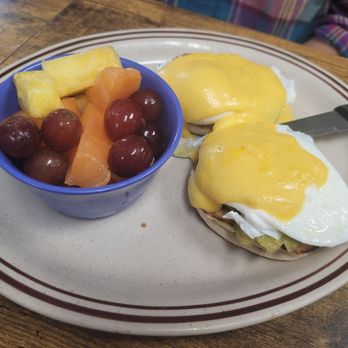 Twisted Biscuit Cafe - Eggs benedict with a fruit bowl. - Breakfast & Brunch Near Me - Palm Bay, Florida