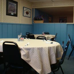 a dining room with tables and chairs