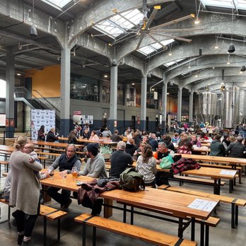 Rhinegeist Brewery - a large group of people sitting at tables - Breweries Near Me - Cincinnati, Ohio