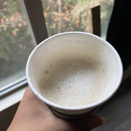 a person holding a cup of coffee a person holding a cup of coffee