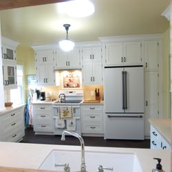 Reed's Kitchens & Baths - Dura Supreme inset cabinetry in white and Deckton counter tops designed and installed by Reeds'Kitchens & Baths